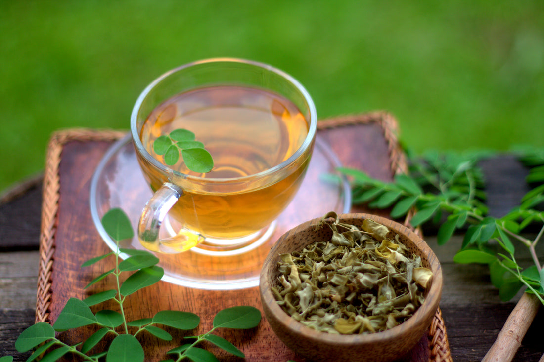 A Glass Of Moringa Tea With Sun Dried Leaves